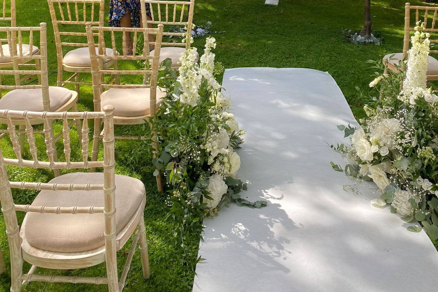 Garden wedding ceremony aisle with white flowers